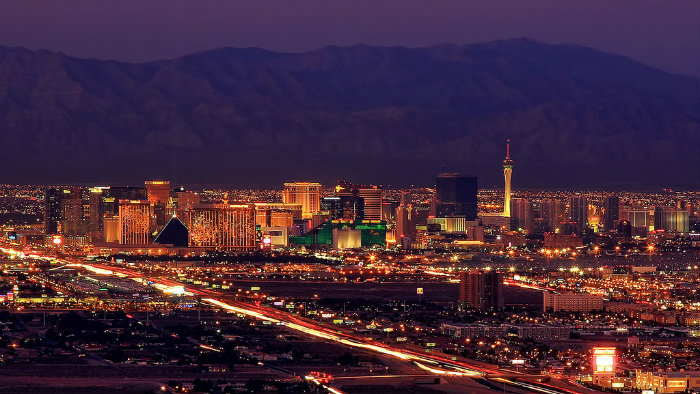 An image of the Las Vegas strip with mountains in the background.